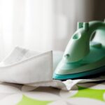 Immagine di un ferro da stiro con piastra bruciata e prodotti per la pulizia.